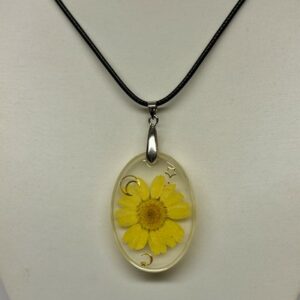 Pendentif ovale transparent avec fleur jaune fluorescent