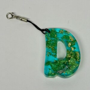 Porte clef vert paillettes or lettre D